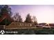 Entrance signage for the Trailstone community surrounded by trees and lush landscaping at 17085 W 92Nd Loop, Arvada, CO 80007