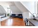 Spacious attic room features hardwood floors, a comfortable blue sofa, and cozy decor at 2358 N Ogden St # B, Denver, CO 80205