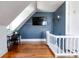 Charming attic room features hardwood floors, a flat-screen TV, and a quaint desk area at 2358 N Ogden St # B, Denver, CO 80205