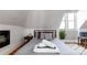 Bright attic bedroom with a plush bed, large windows, and a stylish nightstand at 2358 N Ogden St # B, Denver, CO 80205