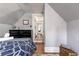 Bedroom featuring a dresser, hardwood floors, and doorway to additional living space at 2358 N Ogden St # B, Denver, CO 80205