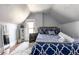 Charming bedroom with a patterned comforter, wood floors, and bright window at 2358 N Ogden St # B, Denver, CO 80205