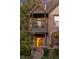 Close-up of a brick house featuring a balcony and a inviting pink front door at 2358 N Ogden St # B, Denver, CO 80205