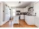 Bright kitchen with white cabinetry, granite countertops, and modern appliances at 2358 N Ogden St # B, Denver, CO 80205