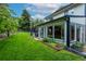 Expansive backyard showcasing a lush lawn and a beautiful sunroom extension at 14428 W Ellsworth Pl, Golden, CO 80401