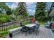 Spacious outdoor deck for dining and relaxing, complemented by a lush backyard at 14428 W Ellsworth Pl, Golden, CO 80401