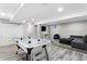 Finished basement featuring an air hockey table, a gray couch, an entertainment area, and recessed lighting at 14428 W Ellsworth Pl, Golden, CO 80401
