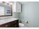 Bright bathroom featuring a granite countertop and a classic wooden framed mirror at 14428 W Ellsworth Pl, Golden, CO 80401