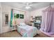 Bright bedroom with a pastel bed, a desk, and a canopy for a cozy and playful space at 14428 W Ellsworth Pl, Golden, CO 80401