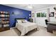 Comfortable bedroom with a ceiling fan, a bed, a bookcase, and a window for a relaxing retreat at 14428 W Ellsworth Pl, Golden, CO 80401