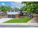 Charming two-story home featuring a well-manicured lawn, brick accents, and a cozy front patio at 14428 W Ellsworth Pl, Golden, CO 80401