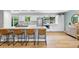 Stylish kitchen with stainless steel appliances, a granite island, and adjacent light-filled living space at 14428 W Ellsworth Pl, Golden, CO 80401