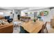 Bright, open kitchen with stainless steel appliances, island seating, and an adjacent dining area at 14428 W Ellsworth Pl, Golden, CO 80401