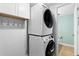 Well-equipped laundry area with a stacked washer and dryer for space-saving convenience at 14428 W Ellsworth Pl, Golden, CO 80401