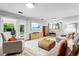 Comfortable living room with modern decor, a TV, a sliding door, and ample seating at 14428 W Ellsworth Pl, Golden, CO 80401