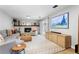Cozy living room with a fireplace, modern furniture, and a large screen TV at 14428 W Ellsworth Pl, Golden, CO 80401