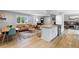 Sunlit living space with hardwood floors, a modern kitchen, and an inviting seating area at 14428 W Ellsworth Pl, Golden, CO 80401