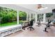 Bright sunroom with large windows, a skylight, and exercise equipment overlooking the lush green backyard at 14428 W Ellsworth Pl, Golden, CO 80401