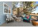 Cozy back deck featuring a stone fire pit surrounded by comfortable chairs, ideal for enjoying the outdoors at 17076 W 71St Pl, Arvada, CO 80007