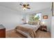 Bedroom with ceiling fan, side tables and lamps, and large window with natural light at 17076 W 71St Pl, Arvada, CO 80007