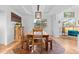 Charming dining room with a wooden table and benches, unique lighting, and eye-catching decor at 17076 W 71St Pl, Arvada, CO 80007