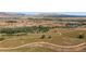 Expansive land with diverse greenery, meandering trails, and distant views of the mountains and city at 4286 S Eldridge St # 202, Morrison, CO 80465