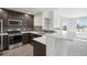 The modern kitchen features stainless appliances, beautiful backsplash, white countertops, and a breakfast bar at 4286 S Eldridge St # 202, Morrison, CO 80465
