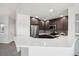 Modern kitchen boasts stainless appliances, dark wood cabinets, and a breakfast bar with white countertops at 4286 S Eldridge St # 202, Morrison, CO 80465