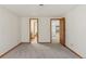 Spacious finished basement with two open doorways showing other rooms at 6358 S Jackson St, Centennial, CO 80121