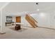 Spacious basement area with carpeted floor, table tennis table, and staircase at 6358 S Jackson St, Centennial, CO 80121