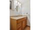 Bathroom vanity with granite countertops, oval mirror, and modern lighting at 6358 S Jackson St, Centennial, CO 80121