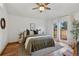 Comfortable bedroom with natural light, ceiling fan, and private access to outdoor space at 6358 S Jackson St, Centennial, CO 80121