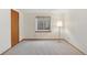 Bedroom with neutral carpet, window with blinds, and a floor lamp at 6358 S Jackson St, Centennial, CO 80121