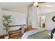 Bright bedroom featuring high ceilings, skylight, and hardwood floors with access to bathroom at 6358 S Jackson St, Centennial, CO 80121