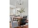 Well-lit dining area with hardwood floors and view to the kitchen at 6358 S Jackson St, Centennial, CO 80121
