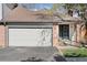 Charming exterior featuring a brick facade, attached garage, and well-maintained landscaping at 6358 S Jackson St, Centennial, CO 80121