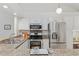 The kitchen features stainless steel appliances, granite countertops, and white cabinetry at 6358 S Jackson St, Centennial, CO 80121
