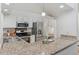Bright kitchen offers granite countertops, stainless steel appliances, and sleek white cabinetry at 6358 S Jackson St, Centennial, CO 80121