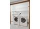Functional laundry area with washer and dryer, and shelving for optimal storage at 6358 S Jackson St, Centennial, CO 80121
