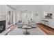 Open living room with a fireplace, modern furnishings, and hardwood floors at 6358 S Jackson St, Centennial, CO 80121