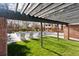 Community pool area with lounge chairs, shaded by a pergola and surrounded by well-manicured greenery at 6358 S Jackson St, Centennial, CO 80121