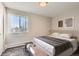 Calm bedroom featuring a large window for natural light, neutral tones, and minimalist decor at 720 S Clinton St # 2D, Denver, CO 80247