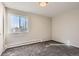 Bright bedroom with natural light, neutral paint, carpeted flooring, and a large window at 720 S Clinton St # 2D, Denver, CO 80247