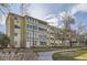 Well-maintained low-rise building surrounded by landscaping and trees at 720 S Clinton St # 2D, Denver, CO 80247