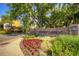 Beautiful entrance to Windsor Gardens featuring lush landscaping, vibrant flowers, and a welcoming sign at 720 S Clinton St # 2D, Denver, CO 80247