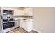 Well-maintained kitchen featuring white cabinets, stainless steel appliances, and a stylish backsplash at 720 S Clinton St # 2D, Denver, CO 80247