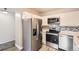Updated kitchen featuring stainless steel appliances, modern backsplash, and wood-style flooring at 720 S Clinton St # 2D, Denver, CO 80247