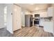 Bright kitchen with stainless steel appliances, updated cabinetry, and a view of the adjacent dining area at 720 S Clinton St # 2D, Denver, CO 80247