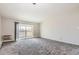 Bright living room with carpeted floors, neutral paint, and access to the balcony at 720 S Clinton St # 2D, Denver, CO 80247