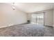 Spacious, carpeted living room with sliding glass doors to balcony, and large windows at 720 S Clinton St # 2D, Denver, CO 80247